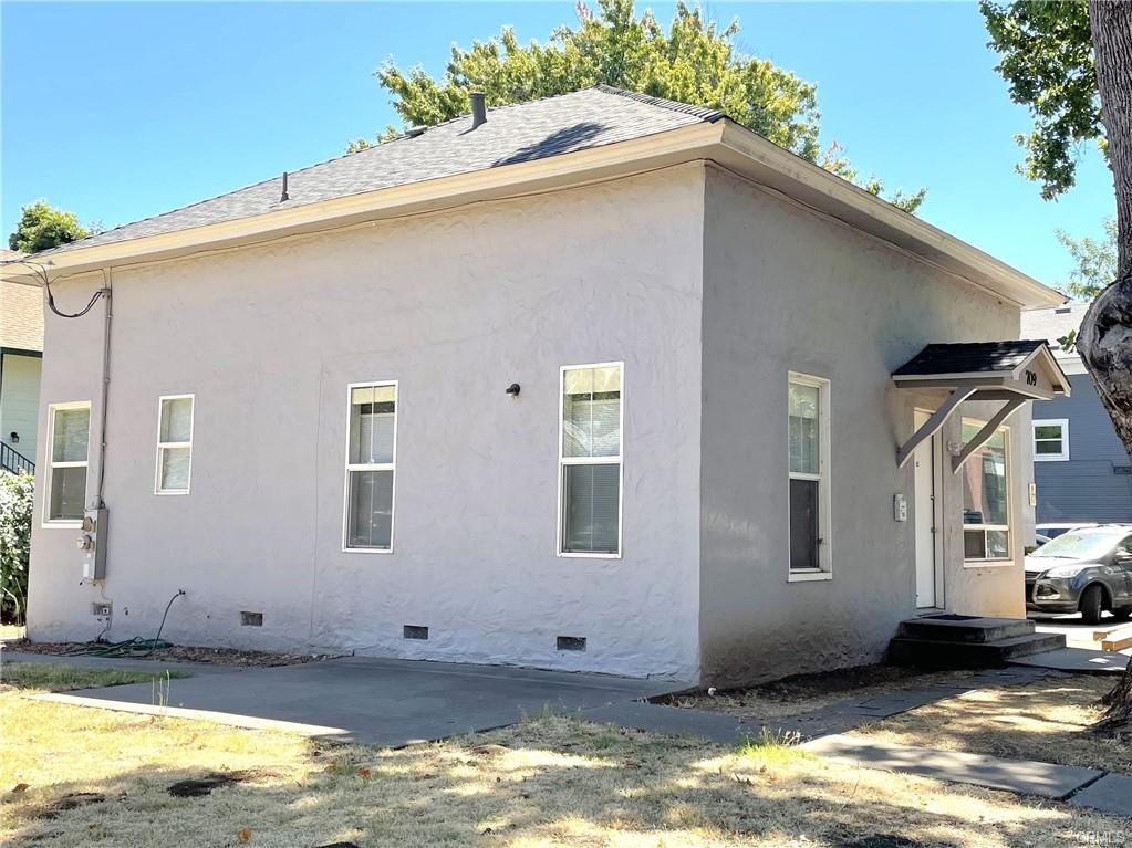 Exterior of 709 W. 2nd Street, a single-story stucco home with a covered front entry